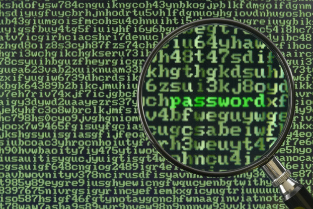 Screen full of alphanumerics depicting encryption and the word password emphasized by a magnifying glass